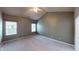 A spacious main bedroom with neutral carpeting, two windows, and a gray accent wall at 5180 Dunewood Way # 57, Avon, IN 46123