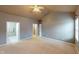 Spacious bedroom with carpet, a ceiling fan, and access to the bathroom and closet at 5180 Dunewood Way # 57, Avon, IN 46123