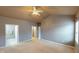 Large bedroom features a ceiling fan and a neutral color palette, creating a serene and relaxing atmosphere at 5180 Dunewood Way # 57, Avon, IN 46123