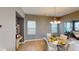 Well-lit dining area with tile flooring, large windows, table, and view of living room at 5180 Dunewood Way # 57, Avon, IN 46123