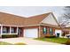 Charming brick home featuring a two-car garage, well-maintained lawn, and inviting front porch at 5180 Dunewood Way # 57, Avon, IN 46123