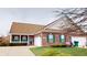 Charming brick house with a two-car garage, manicured lawn, and inviting front porch with green shutters at 5180 Dunewood Way # 57, Avon, IN 46123