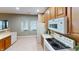 Well-lit kitchen with wooden cabinets, white appliances, and a view of the outdoors at 5180 Dunewood Way # 57, Avon, IN 46123