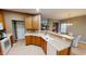 Well-lit kitchen with light wood cabinets, counterspace, and modern appliances at 5180 Dunewood Way # 57, Avon, IN 46123