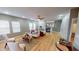Spacious living room with hardwood floors, modern furniture, fireplace, and large windows overlooking backyard at 5180 Dunewood Way # 57, Avon, IN 46123