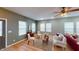 Bright living room featuring hardwood floors, neutral walls, large windows, and stylish furniture at 5180 Dunewood Way # 57, Avon, IN 46123