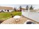 Outdoor patio with stone flooring, white fence, and lawn at 5180 Dunewood Way # 57, Avon, IN 46123