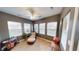 Cozy sun room with large windows, neutral-colored walls, ceiling fan, and comfortable furniture at 5180 Dunewood Way # 57, Avon, IN 46123
