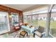 Cozy sunroom featuring brick accent wall, tile flooring, and outdoor views at 5180 Dunewood Way # 57, Avon, IN 46123