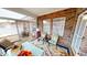 Relaxing sunroom with brick walls, windows, and cozy seating, with outdoor views at 5180 Dunewood Way # 57, Avon, IN 46123