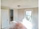 This sunlit bedroom has bare floors and a closet at 55 S 4Th Ave, Beech Grove, IN 46107