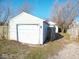 This property includes a detached one car garage with a white exterior and panel garage door at 55 S 4Th Ave, Beech Grove, IN 46107