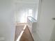 A carpeted hallway leading to a door and closet at 55 S 4Th Ave, Beech Grove, IN 46107