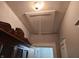 Attic access panel in the ceiling, with a vintage light fixture and partial view of the hallway below at 611 W South St, Shelbyville, IN 46176
