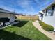 Backyard featuring a fenced yard, fresh grass, and a shed in the background at 611 W South St, Shelbyville, IN 46176
