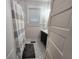 Bathroom featuring stylish patterned floors, a modern vanity, and a shower with a neutral-striped curtain at 611 W South St, Shelbyville, IN 46176