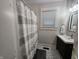 Bathroom featuring stylish patterned floors, a modern vanity, and a shower with a neutral-striped curtain at 611 W South St, Shelbyville, IN 46176