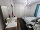 Comfortable bedroom featuring a decorative mirror, a modern chandelier, and a closet at 611 W South St, Shelbyville, IN 46176