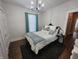 Stylish bedroom with decorative pillows, patterned bedding, an area rug, and window offering natural light at 611 W South St, Shelbyville, IN 46176