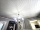 Unique tongue and groove ceiling design with a vintage chandelier at 611 W South St, Shelbyville, IN 46176