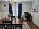 Cozy dining room showcasing wood floors, an elegant chandelier and an adjacent desk area at 611 W South St, Shelbyville, IN 46176