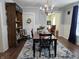 Elegant dining room with a chandelier, a dining table, and a view into the living room at 611 W South St, Shelbyville, IN 46176