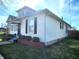 Charming home featuring vinyl siding, manicured shrubs, and a well maintained lawn at 611 W South St, Shelbyville, IN 46176