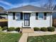 Attractive home with white siding, black shutters, and a landscaped front yard at 611 W South St, Shelbyville, IN 46176