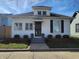 Charming white two-story home with a dormer window and well-maintained landscaping at 611 W South St, Shelbyville, IN 46176