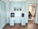 Efficient kitchen area featuring light green cabinetry, practical layout and built-in appliances at 611 W South St, Shelbyville, IN 46176
