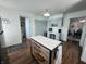 Bright kitchen showcasing a rolling island, light green cabinets, and seamless access to dining area at 611 W South St, Shelbyville, IN 46176