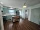 Spacious kitchen featuring light green cabinetry, stainless appliances, and a movable kitchen island at 611 W South St, Shelbyville, IN 46176