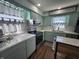 Charming kitchen with light green cabinets, white countertops, and stainless steel appliances at 611 W South St, Shelbyville, IN 46176