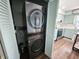 A convenient laundry setup featuring a modern, stacked washer and dryer unit, located adjacent to the kitchen at 611 W South St, Shelbyville, IN 46176