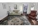 Cozy living room with a sofa, decorative pillows, and a view into an adjacent bedroom at 611 W South St, Shelbyville, IN 46176