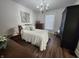 Comfortable main bedroom with a large bed, wooden furniture, light-colored walls, and a decorative chandelier at 611 W South St, Shelbyville, IN 46176