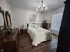 Comfortable main bedroom with a large bed, wooden furniture, light-colored walls, and a decorative chandelier at 611 W South St, Shelbyville, IN 46176