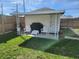 Covered patio area with two chairs, outdoor furniture, and a grill at 611 W South St, Shelbyville, IN 46176