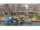 Lakefront homes offer multiple decks, a lakeside dock, and mature trees surrounding manicured lawn at 6290 Grouse Dr, Nineveh, IN 46164
