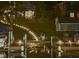 Waterfront backyard featuring a lit staircase and dock at night for relaxed outdoor living at 6290 Grouse Dr, Nineveh, IN 46164