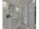 Clean bathroom featuring a vanity with storage, mirrored cabinet, and a shower stall with glass doors at 6290 Grouse Dr, Nineveh, IN 46164