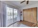 This bedroom includes sliding glass doors, wood floors, and closet space at 6290 Grouse Dr, Nineveh, IN 46164