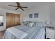 Cozy bedroom showcasing a queen bed, white paneled walls, wood floors and ceiling fan at 6290 Grouse Dr, Nineveh, IN 46164