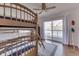 Bedroom features wood bunk beds, hardwood floors, sliding glass doors leading to a deck, and ceiling fan at 6290 Grouse Dr, Nineveh, IN 46164