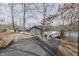 Exterior view of a well-maintained home with a long driveway and lake access at 6290 Grouse Dr, Nineveh, IN 46164