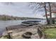 Outdoor living space with a firepit and dock offering scenic views of the lake and boats at 6290 Grouse Dr, Nineveh, IN 46164