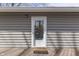 Cozy home entrance featuring a glass door, wood-look siding, and a 'Welcome' mat on the porch at 6290 Grouse Dr, Nineveh, IN 46164