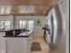 Kitchen with granite countertops, stainless steel appliances, white cabinetry, and lake views at 6290 Grouse Dr, Nineveh, IN 46164
