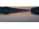 Calm lake view at dusk with subtle reflections, creating a peaceful and serene atmosphere at 6290 Grouse Dr, Nineveh, IN 46164