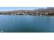 Scenic lake view showcasing waterfront homes along the shoreline and beautiful blue water at 6290 Grouse Dr, Nineveh, IN 46164